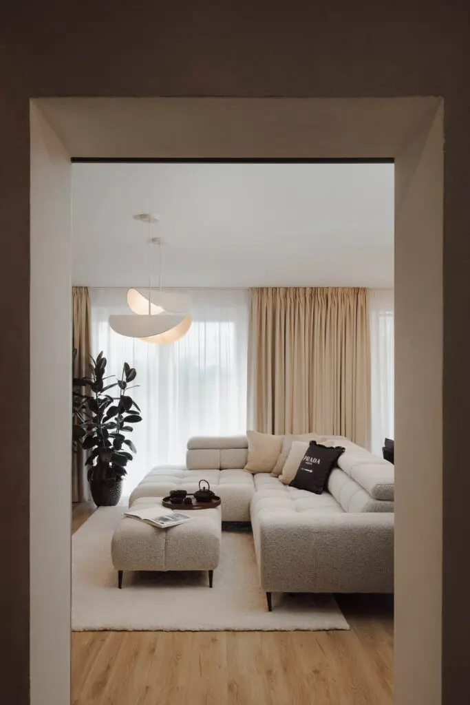 Průhled do moderního interiéru luxusního obývacího pokoje s béžovým gaučem.